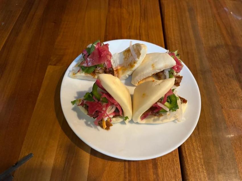 The baos are showstoppers — soft, fluffy buns filled with savoury toppings, loaded with pickles and herbs that keep every bite fresh and balanced. Photo: Sujoy Dhar