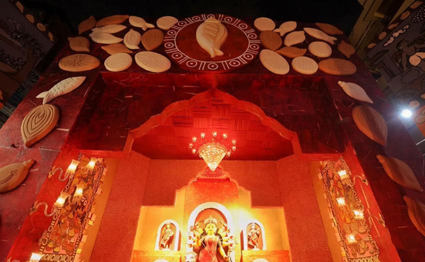 Sweets from rosogolla to sandesh, alongside the names of Bengal’s legendary confectioners, are woven into the theme of the Wellington Square pandal. Photo: Avishek Mitra