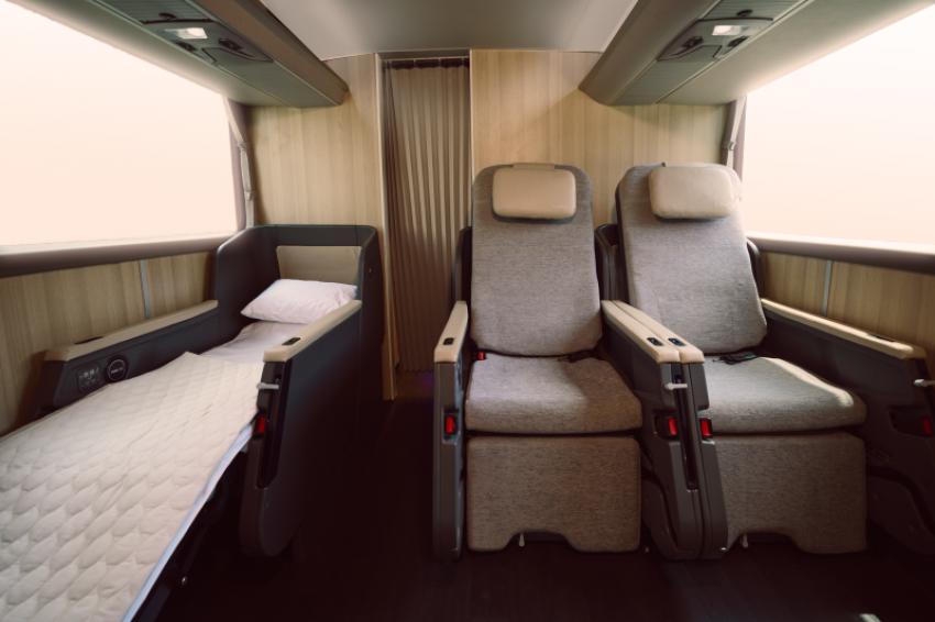 Every seat is equipped with an individual reading light, a convenient mini table for late-night work or snacks, and charging ports. Photo: Remo Vettori/Twiliner